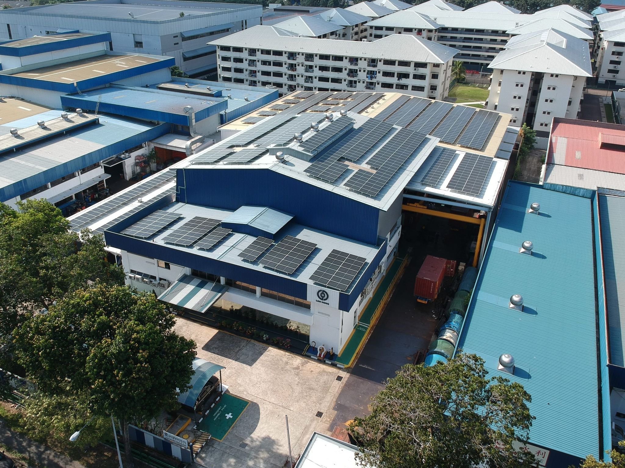 Aerial view of solar panels installed on rooftops of industrial buildings in the East region of Singapore, part of Aggregated Solar Asset producing 1044.7 kWp.